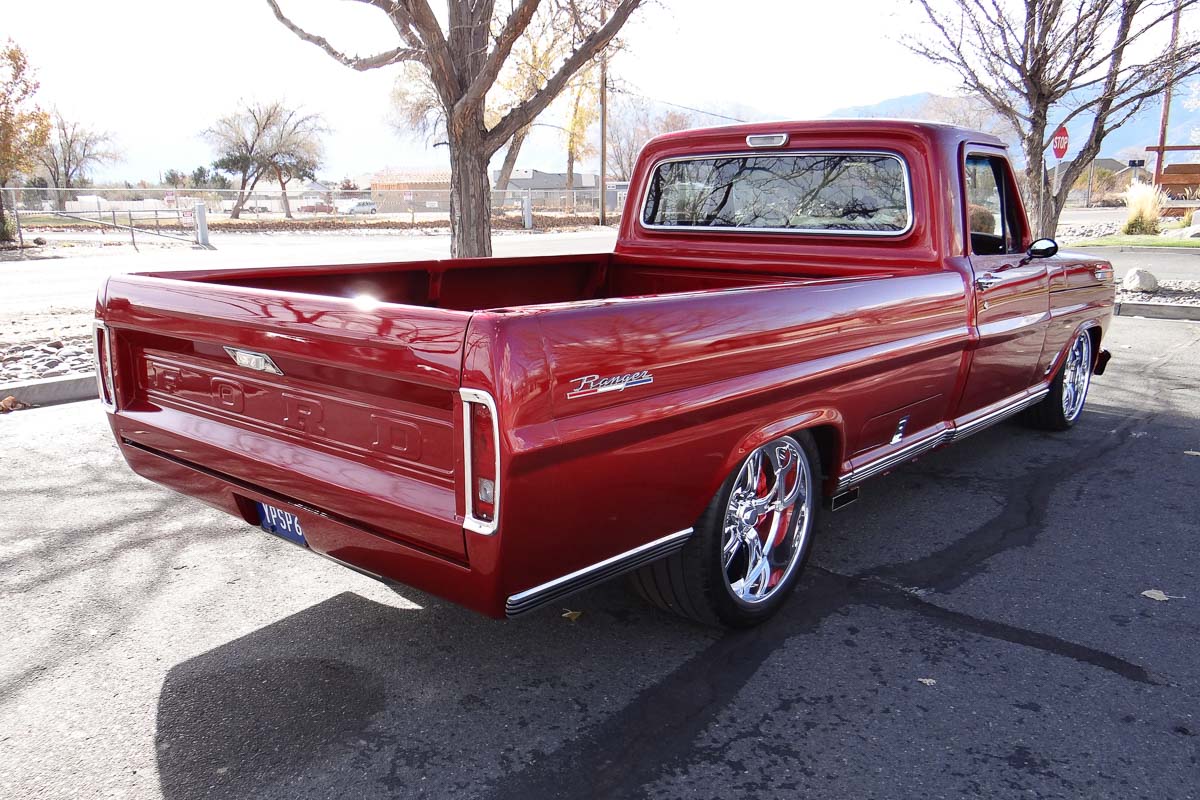 Side angle of the 1968 Ford F100 Ranger showcasing its lowered stance and clean body lines. Side angle of the 1968 Ford F100 Ranger showcasing its lowered stance and clean body lines.