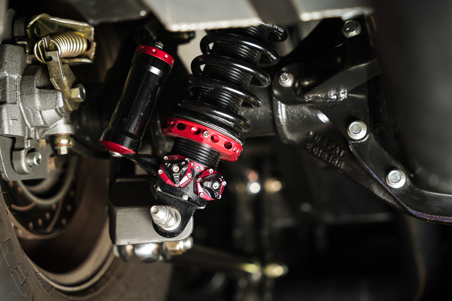 Close-up of the rear suspension on the 1956 Chevy 3100, featuring QA1 MOD shocks and a Watts link setup. Close-up of the rear suspension on the 1956 Chevy 3100, featuring QA1 MOD shocks and a Watts link setup.